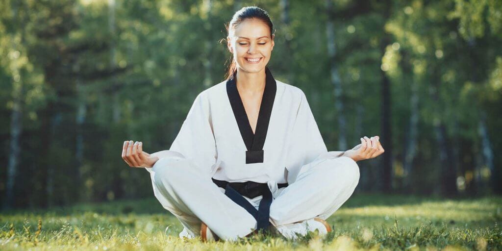 Martial Arts Lessons for Adults in Brampton ON - Happy Woman Meditated Sitting Background